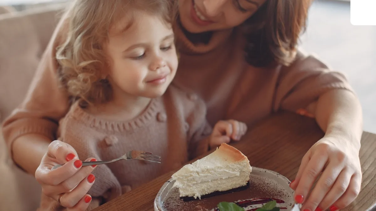 A baby eating a healthy meal with sources of fat