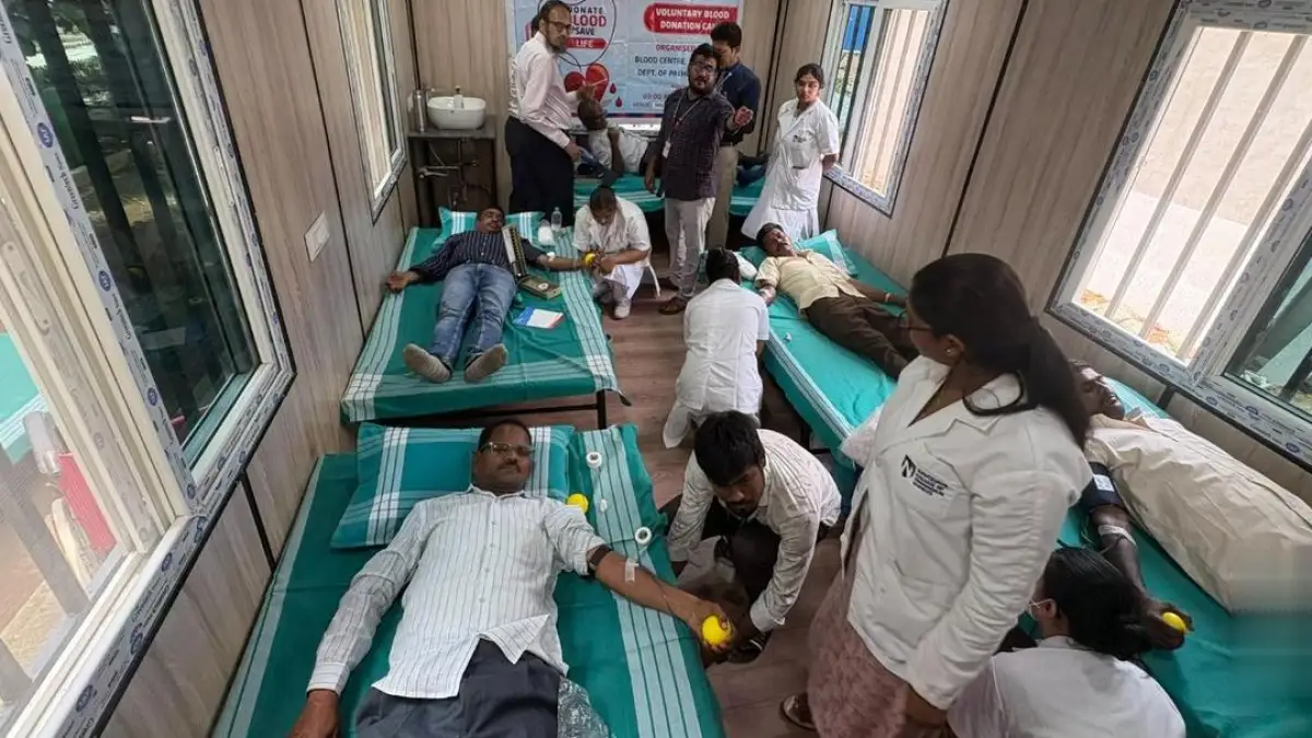 A photo of a blood donation camp in Raichur, with people donating blood and medical staff present