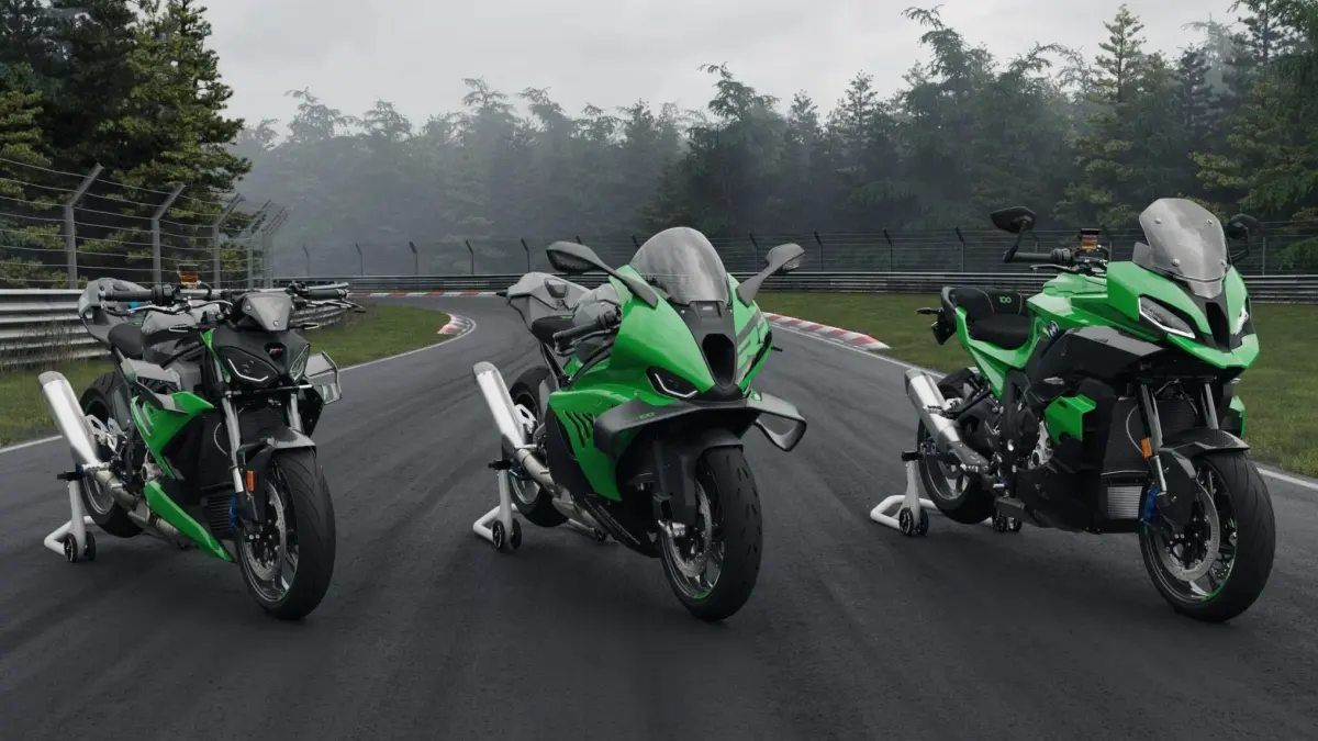 Three BMW 100 Jahre Nürburgring motorcycles displayed side‑by‑side in green livery on a racetrack