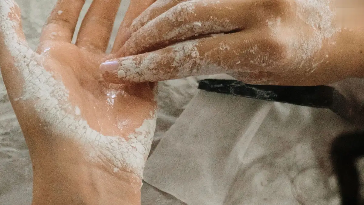 A person holding a burned hand under cool running water