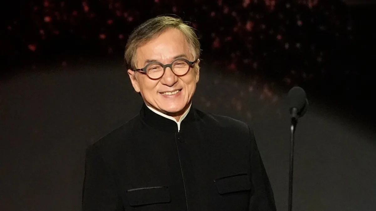 Jackie Chan smiling and waving at fans