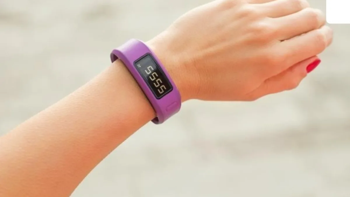 A person wearing a fitness band, with a cityscape in the background