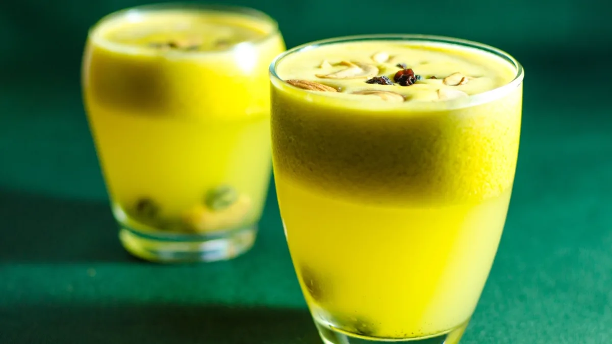 A glass of amla juice with a slice of Indian gooseberry