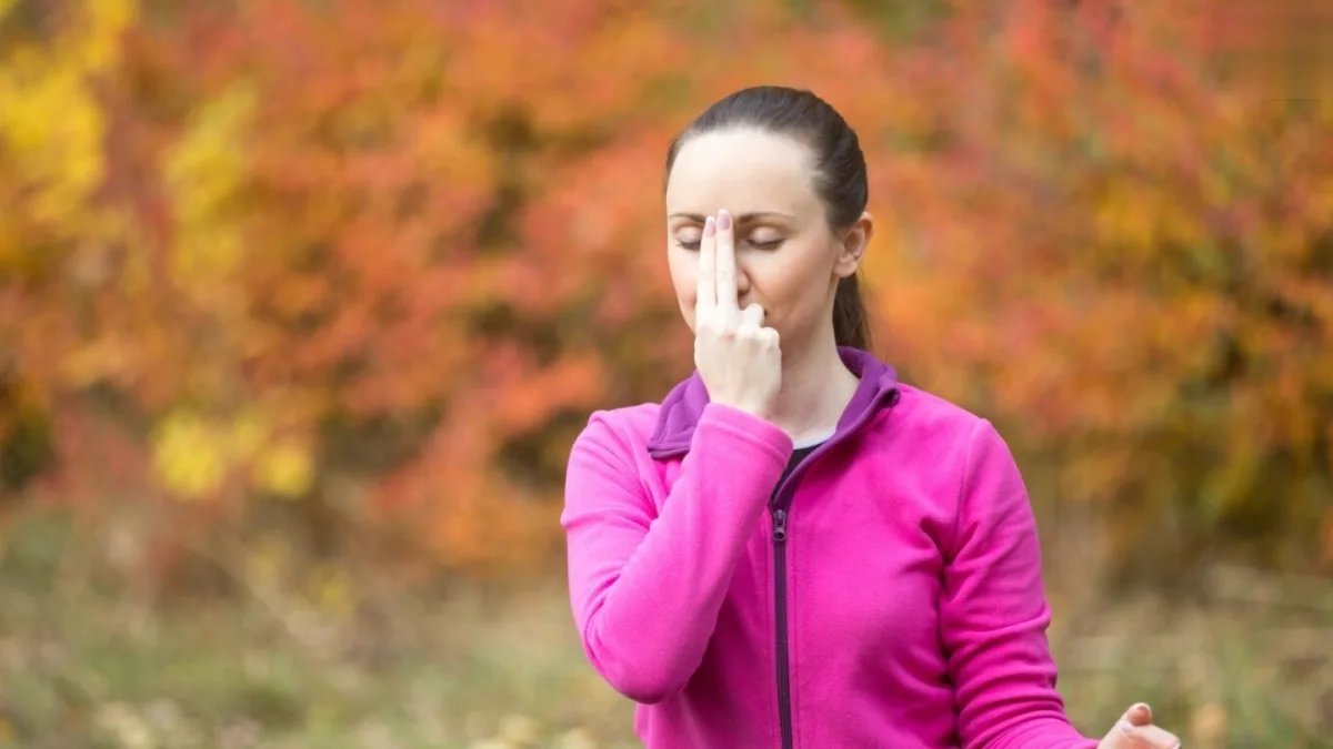 A person practicing deep breathing exercises in a peaceful environment