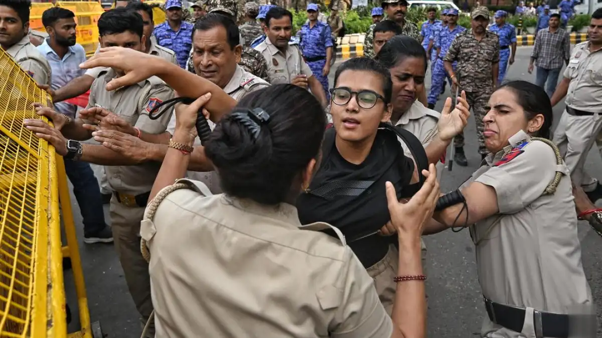 A protest in Delhi with people holding signs and banners