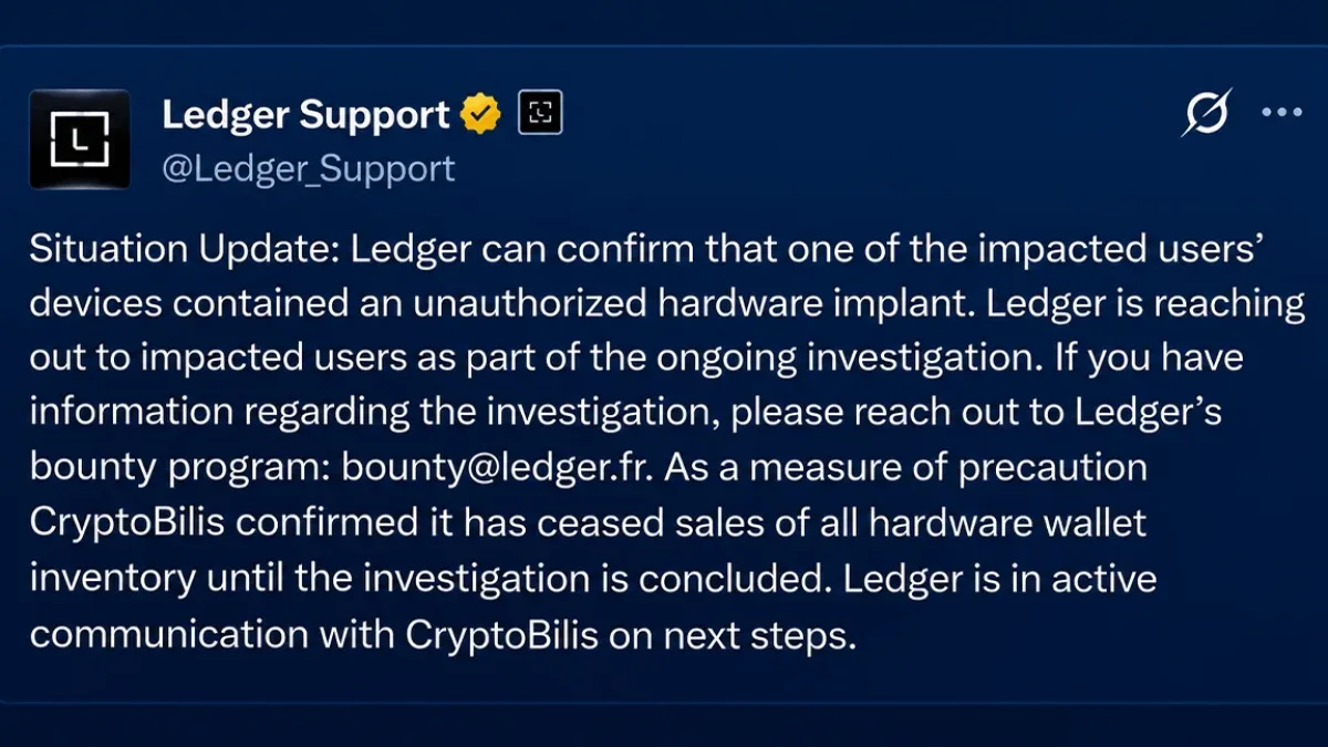 A Ledger hardware wallet with a warning sign
