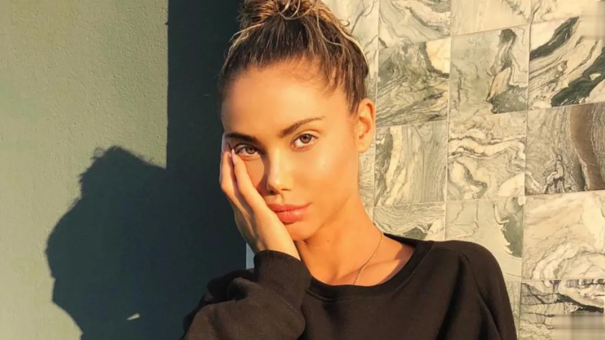 Sahara Ray, an Australian model and swimwear designer, smiling and posing in a photo shoot