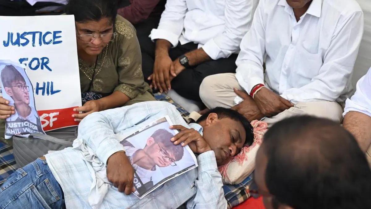 Protesters holding photographs of Sahil Wakode