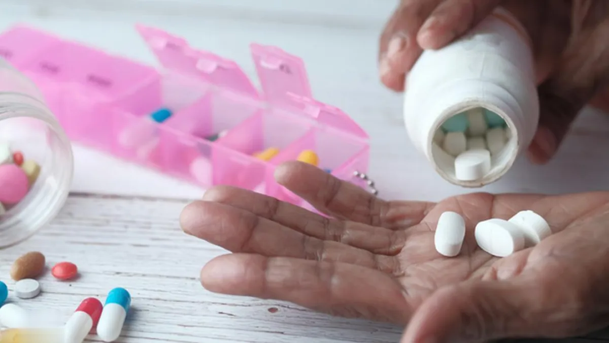A picture of a person holding a packet of medicine