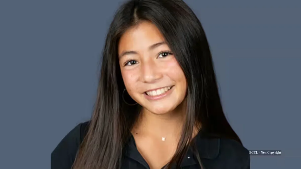 A teenage girl holding a simple air sampler device