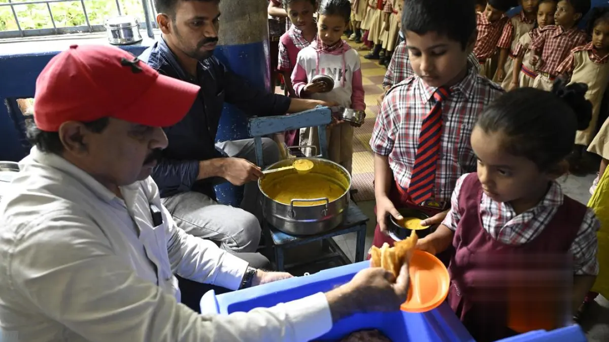 A photo of a schoolchild eating breakfast in a Telangana government school