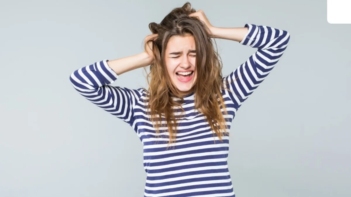 A person pulling out their hair due to trichotillomania