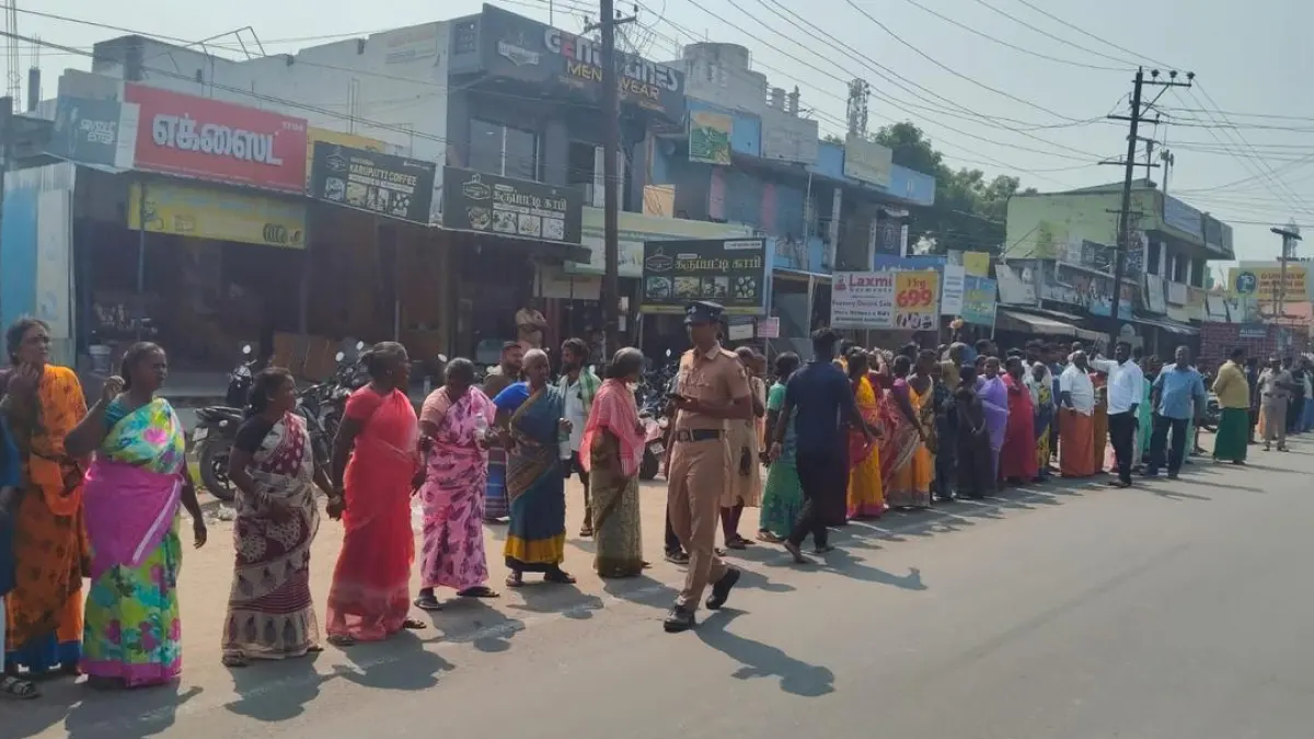 Protesters forming a human chain to protest against silt extraction from an irrigation tank