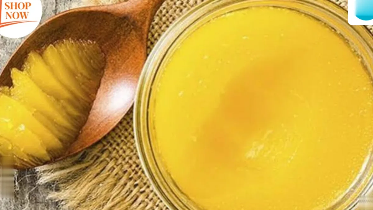 A jar of ghee with a spoon